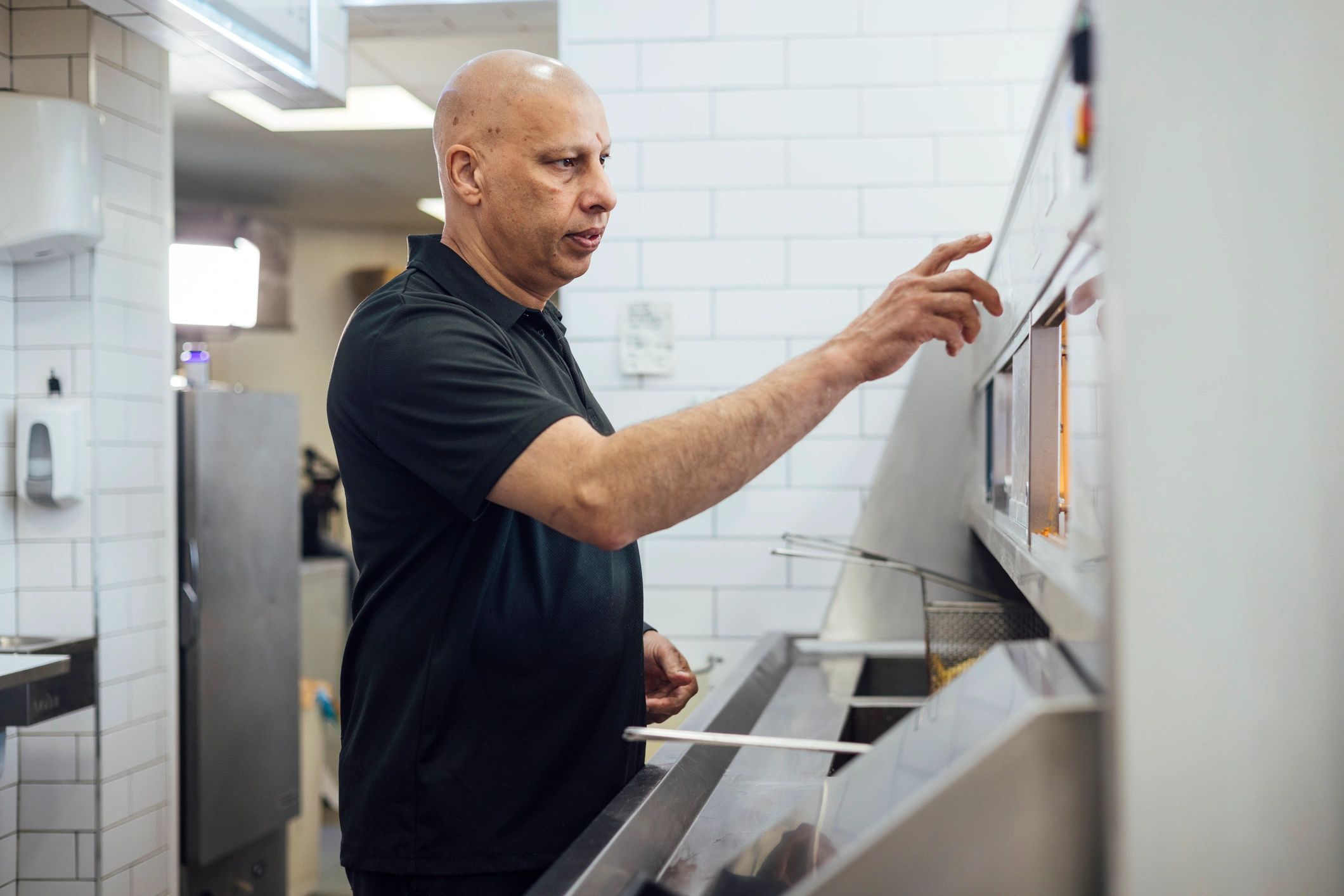 Kitchen professional operating commercial cooking equipment